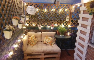 Terraza chillout con celosías y seto artificial de hiedra. Decorado con luces